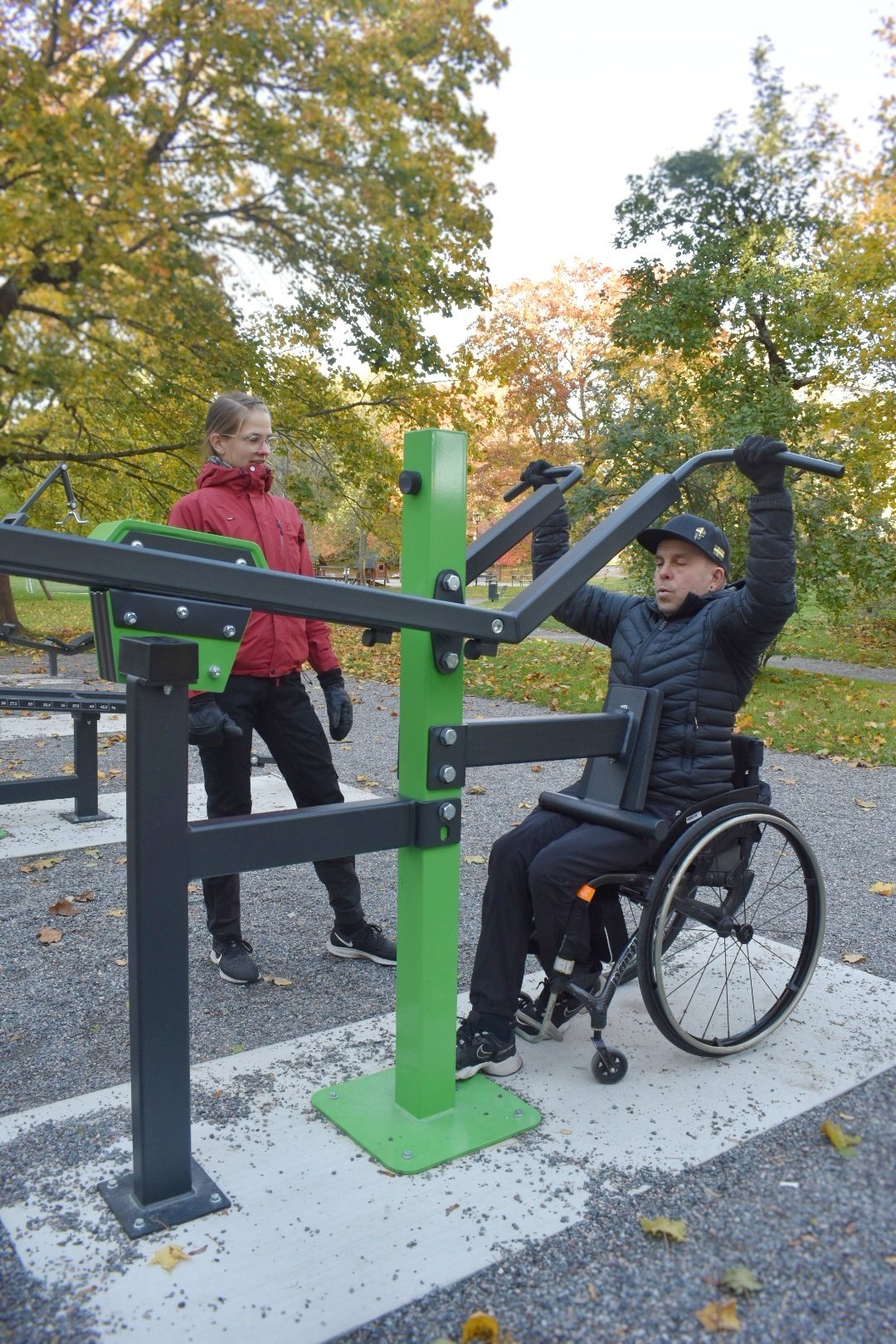 A person in a wheelchair exercising with Free access lat pulldown