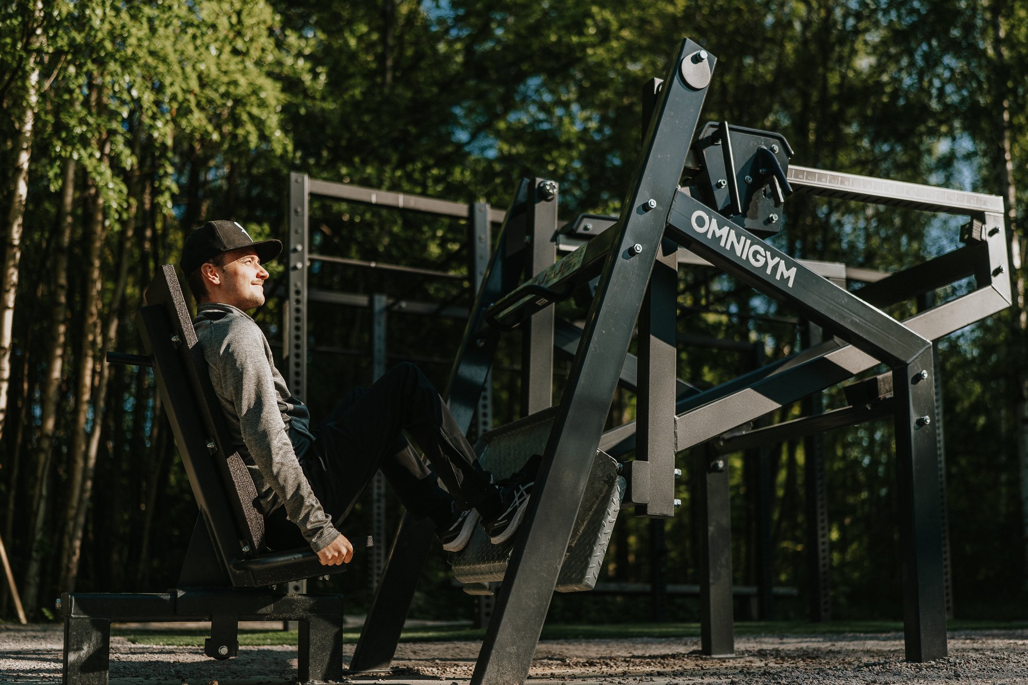 a guy doing leg press outdoors