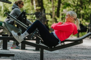 A woman training abs on abdominal bench