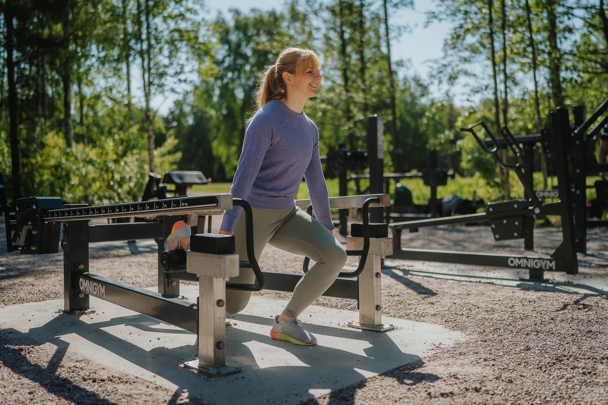 A woman doin single leg squat outdoors