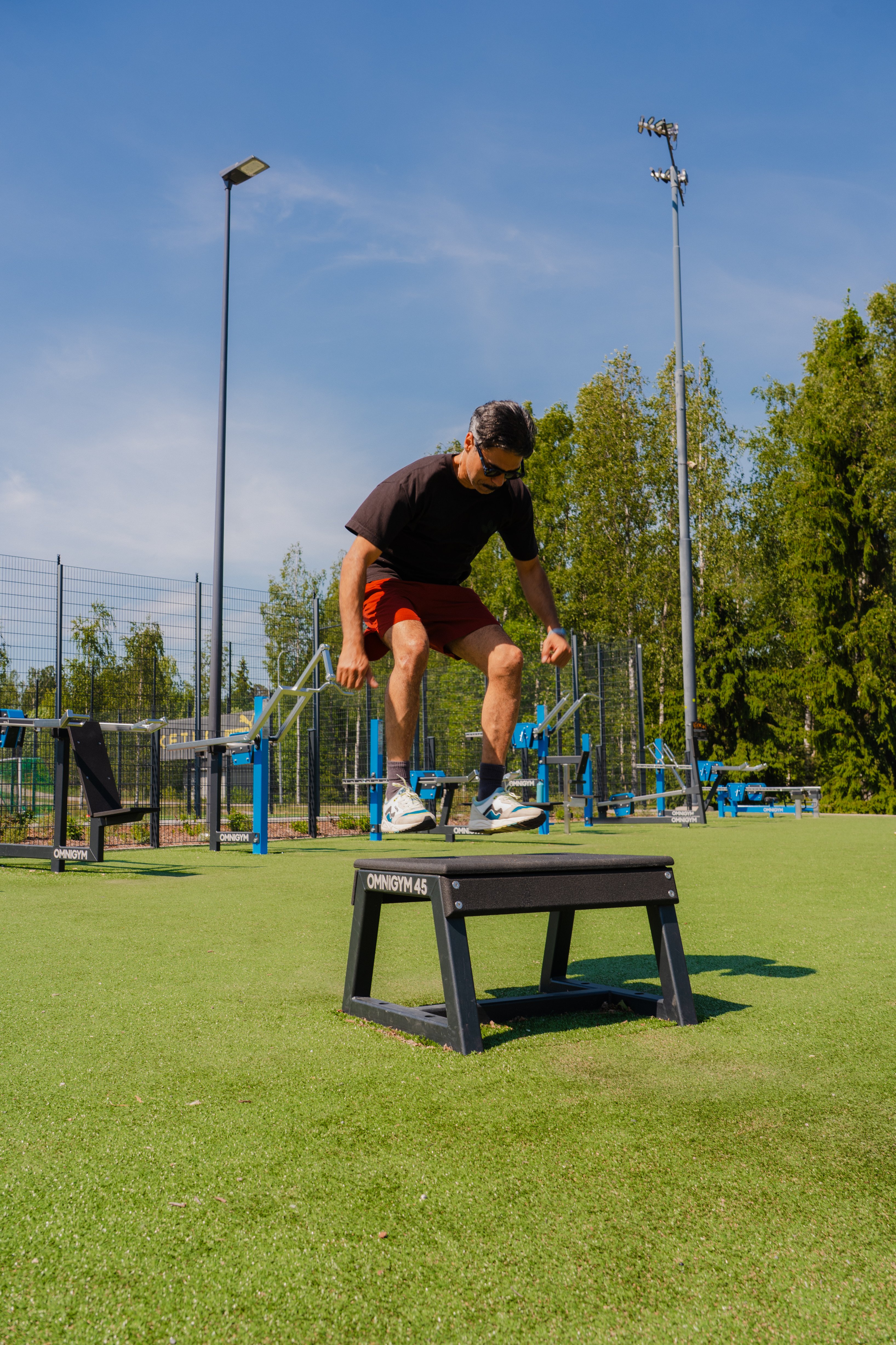 A man jumping up on to a ply box outdoors.