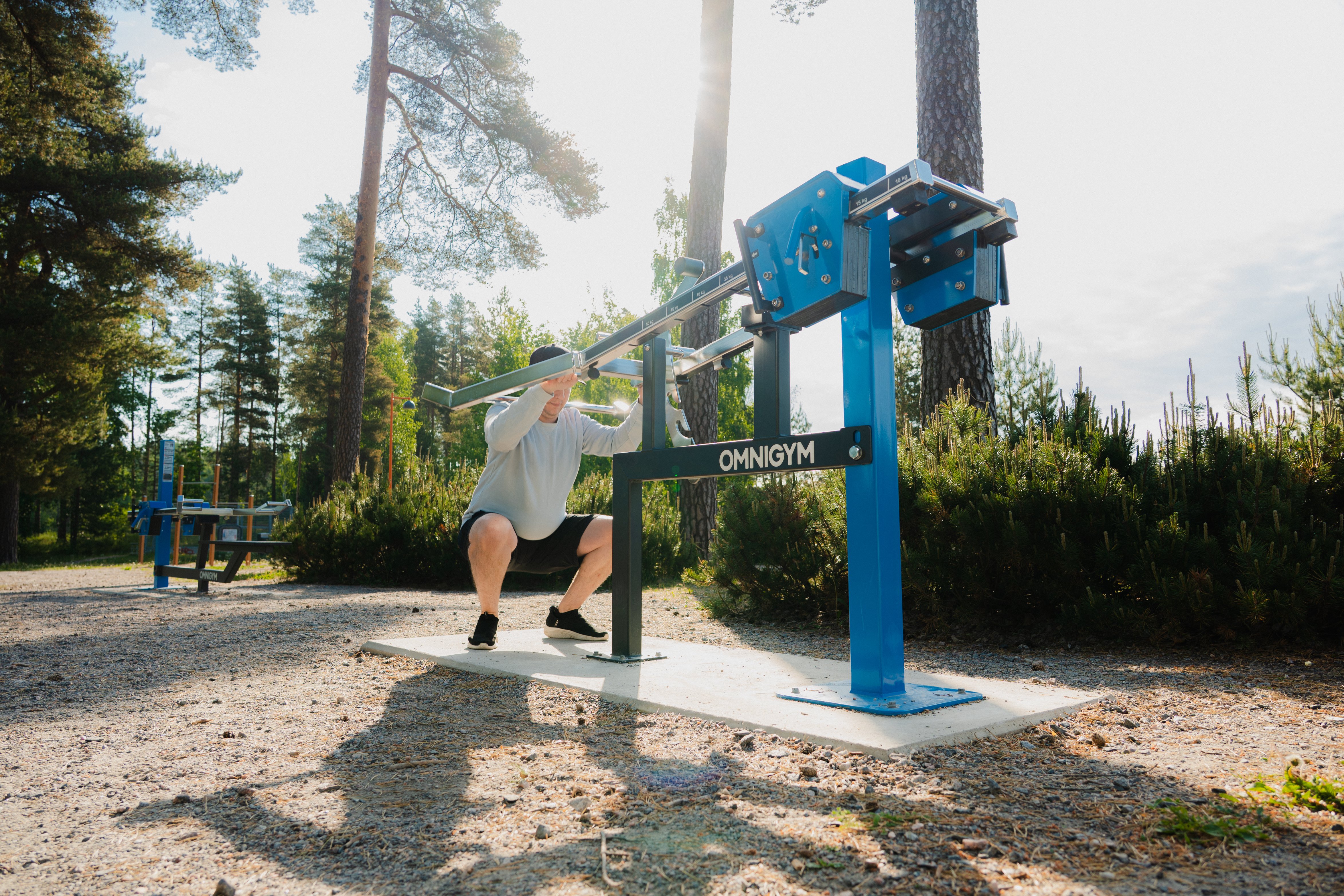 A man doing squats at an outdoor gym in Veikkola Finland