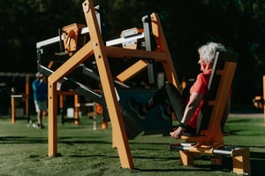 A senior working out at an outdoor gym