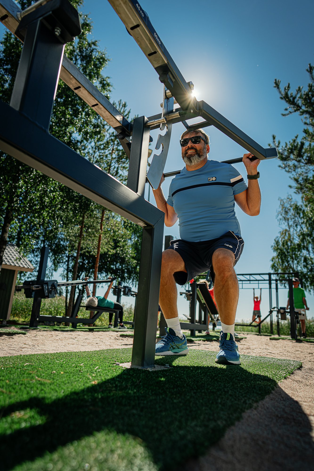 Squats at an outdoor gym by a beach