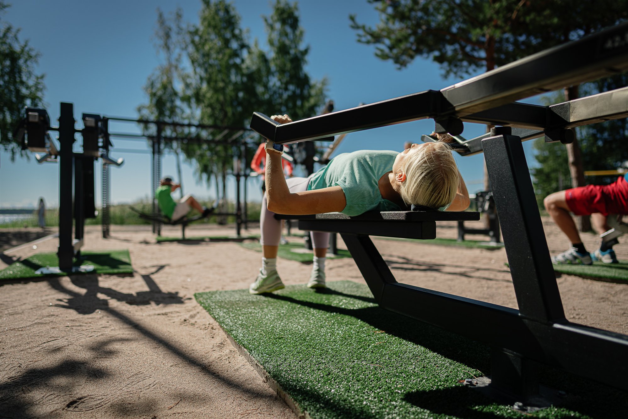 A female doing bench press at a beach