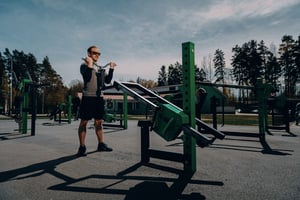 A man training biceps at an outdoor gym