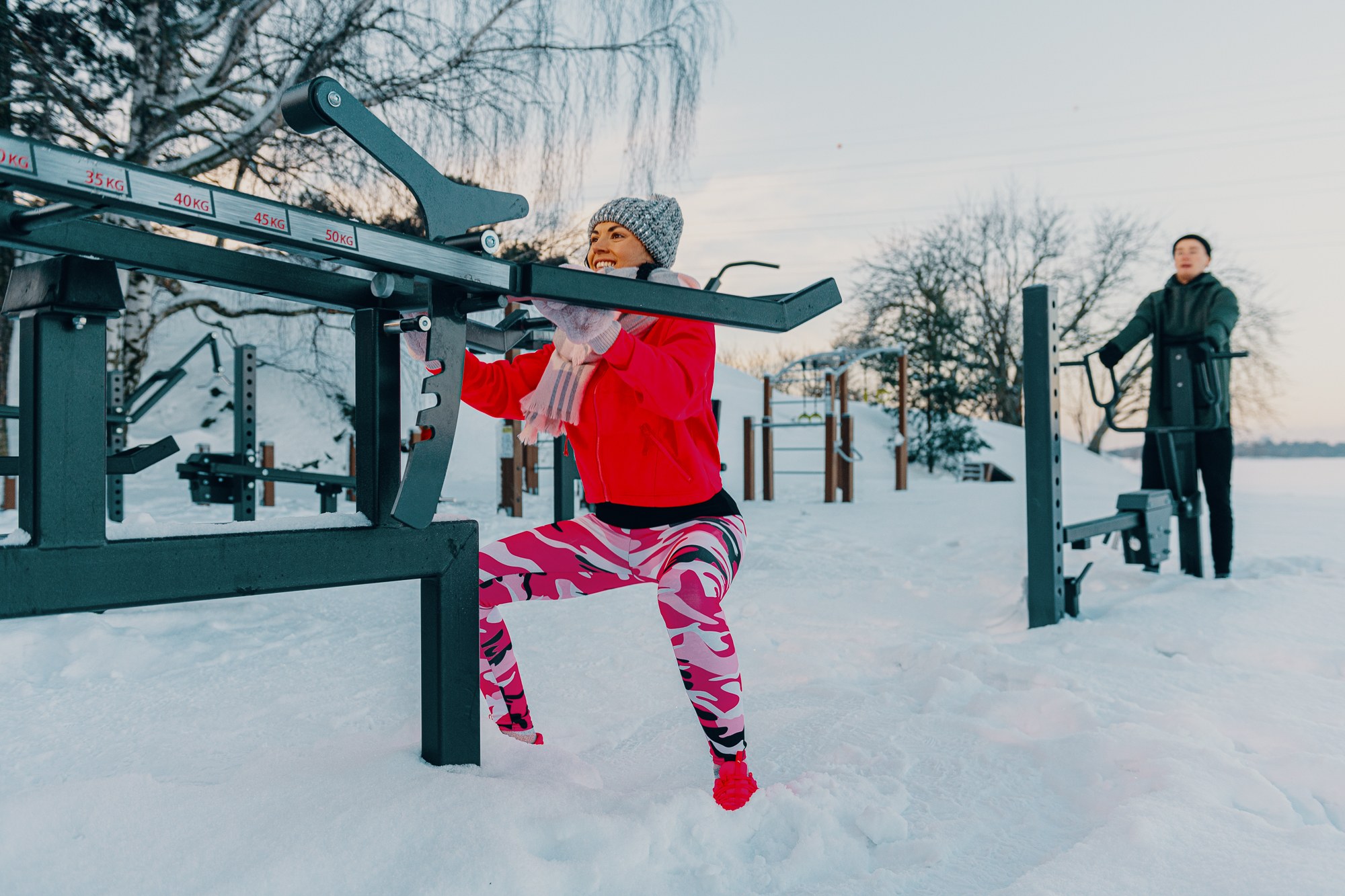 A person doing squats in winter outdoors