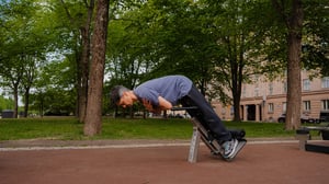 A man doing back exercise at an outdoor gym in Helsinki