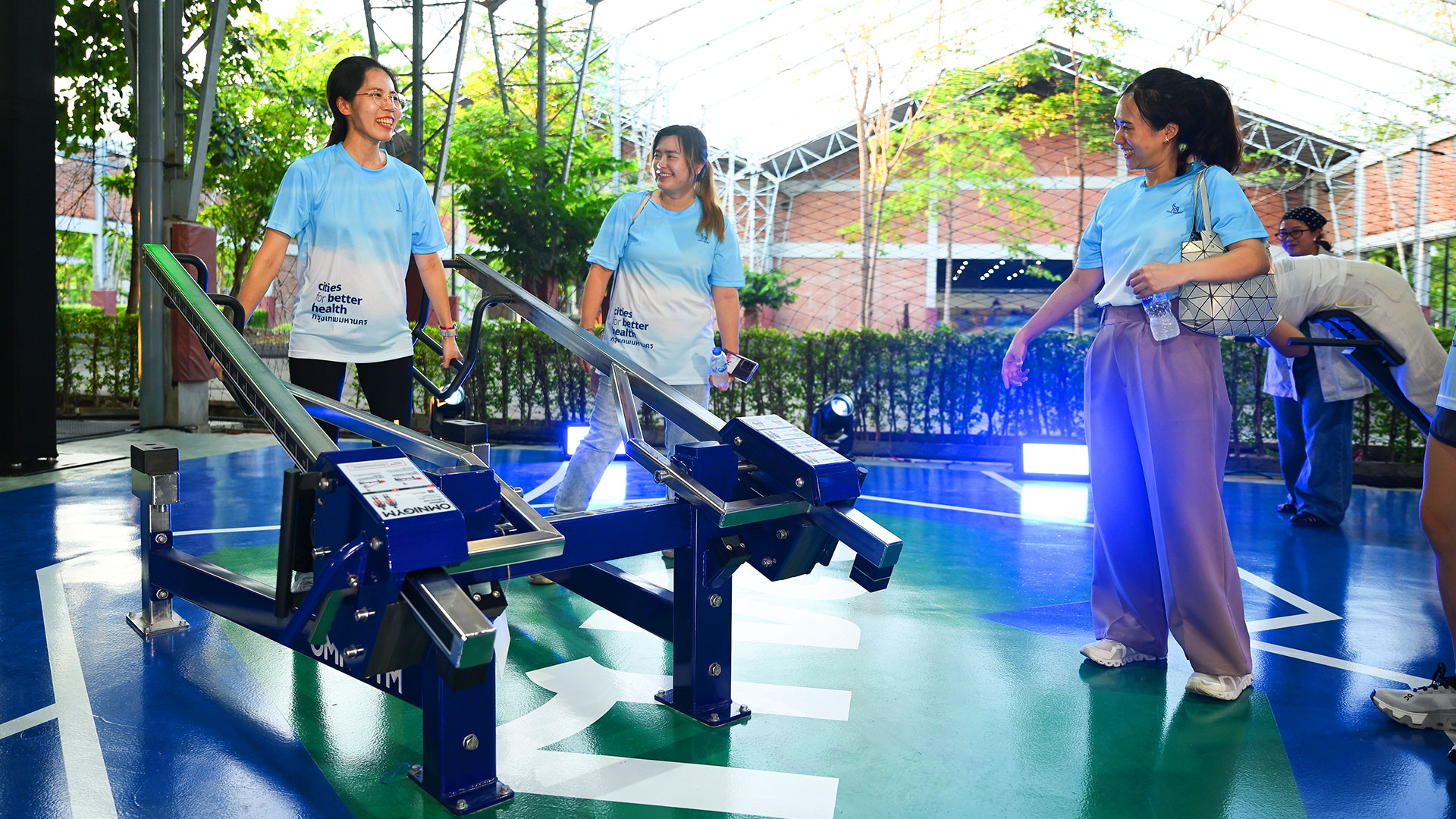 A group of women using the Omnigym Multilift at the public outdoor gym in Benchakitti Sports Center.